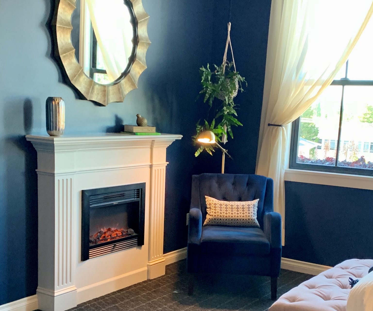 A beautiful fireplace next to an armchair